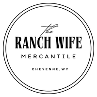 Logo for 'The Ranch Wife Mercantile' with text in a circular design on a white background